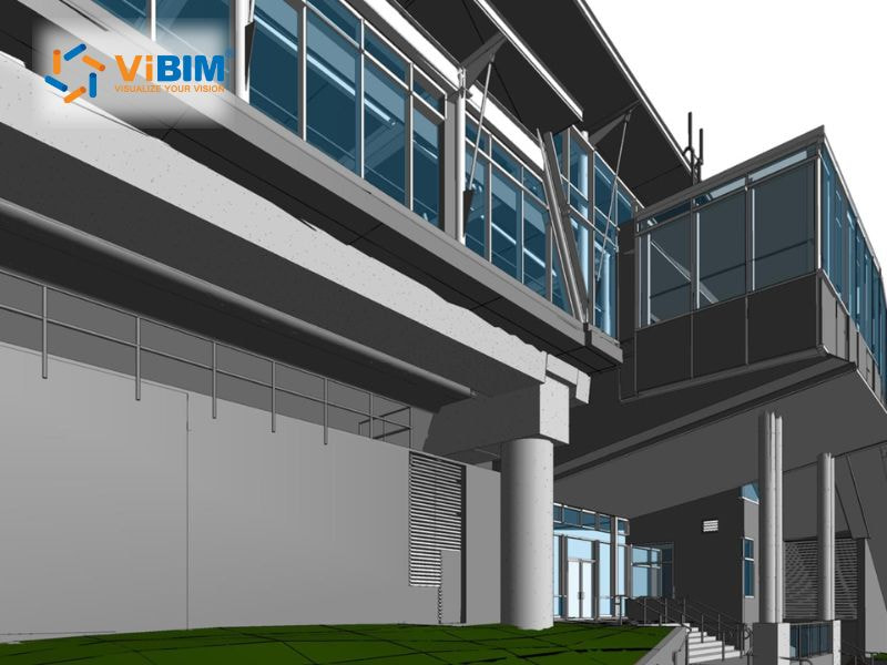 Modern commercial building exterior with blue-tinted windows and entrance canopy in BIM software